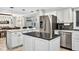 Bright kitchen with stainless steel appliances, white cabinets, and a center island at 3620 Little Rd, Lutz, FL 33548