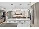 Kitchen with stainless steel refrigerator and island overlooking the dining room at 3620 Little Rd, Lutz, FL 33548