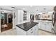 White cabinets and black countertop island with easy access to the open floor plan of this great home at 3620 Little Rd, Lutz, FL 33548