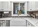 Kitchen features a farmhouse sink and a window that overlooks the backyard at 3620 Little Rd, Lutz, FL 33548