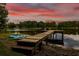 Lake view featuring a dock and kayaks, perfect for water recreation at 3620 Little Rd, Lutz, FL 33548