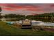 Lake view featuring a dock and kayaks, perfect for water recreation at 3620 Little Rd, Lutz, FL 33548