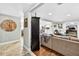 Open-concept living space with hardwood floors, neutral paint, and a seamless flow into the dining and kitchen areas at 3620 Little Rd, Lutz, FL 33548