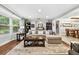 Well-decorated living area with a sectional sofa, bay window, and open access to other living spaces at 3620 Little Rd, Lutz, FL 33548