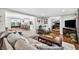 Open-concept living room with hardwood floors and views of kitchen, pool table and office at 3620 Little Rd, Lutz, FL 33548
