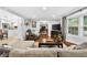 Inviting living room with a cozy fireplace and abundant natural light from the large bay window at 3620 Little Rd, Lutz, FL 33548