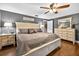 Comfortable main bedroom featuring a large bed, dresser, and warm lighting at 3620 Little Rd, Lutz, FL 33548