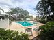 Resort-style community pool with lounge chairs, lush landscaping, and plenty of space for relaxation at 3810 N Oak Dr # N31, Tampa, FL 33611