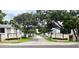 Neighborhood street scene with lush trees, neatly kept lawns, and building signage at 3810 N Oak Dr # N31, Tampa, FL 33611