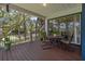 Relaxing on the back porch, surrounded by the beauty of nature, provides a tranquil escape at 389 Grand Bay Dr, Palm Harbor, FL 34683