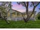 Expansive backyard featuring a covered patio and well-maintained lawn at 389 Grand Bay Dr, Palm Harbor, FL 34683