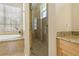 Bathroom featuring a garden tub, walk-in glass door shower, and granite countertops at 389 Grand Bay Dr, Palm Harbor, FL 34683