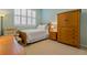 Bedroom with carpet floor, wood furniture, and a window with plantation shutters at 389 Grand Bay Dr, Palm Harbor, FL 34683