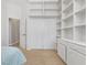 Spacious bedroom with carpet floor, built-in shelving and a closet at 389 Grand Bay Dr, Palm Harbor, FL 34683