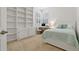 Bedroom with built-in shelving, desk, and plantation shutters at 389 Grand Bay Dr, Palm Harbor, FL 34683