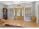 Inviting entryway with hardwood floors, decorative glass door, and transom windows at 389 Grand Bay Dr, Palm Harbor, FL 34683