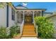 Inviting front porch with stained steps and mature landscaping welcomes you home at 389 Grand Bay Dr, Palm Harbor, FL 34683