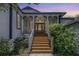 Charming home with a welcoming front porch and beautiful wood stairs at 389 Grand Bay Dr, Palm Harbor, FL 34683