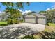 Spacious three-car garage with ample parking on a wide driveway at 389 Grand Bay Dr, Palm Harbor, FL 34683