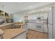 Clean kitchen featuring white appliances, ample counter space, and natural light at 389 Grand Bay Dr, Palm Harbor, FL 34683