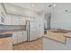 Functional kitchen featuring white cabinets, ample counter space, and modern appliances at 389 Grand Bay Dr, Palm Harbor, FL 34683