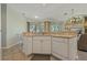 Kitchen with white cabinets, corner sink, and open concept design overlooking the living room at 389 Grand Bay Dr, Palm Harbor, FL 34683