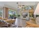 Bright living room with tile floors, large windows, and sliding doors to the deck at 389 Grand Bay Dr, Palm Harbor, FL 34683