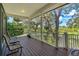 Spacious covered patio with chairs and a view of the landscaped yard and trees at 389 Grand Bay Dr, Palm Harbor, FL 34683