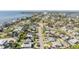 Aerial view of a residential neighborhood with tree-lined streets and varying house styles near the water at 4015 Overlook Ne Dr, St Petersburg, FL 33703