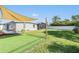 A spacious backyard with green grass, a sunshade, and a white fence creating a private outdoor space at 4015 Overlook Ne Dr, St Petersburg, FL 33703