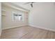 Bright bedroom features light, neutral walls, trim and flooring, a window and ceiling fan at 4015 Overlook Ne Dr, St Petersburg, FL 33703