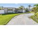 Well-maintained home with mature landscaping, modern exterior, and spacious driveway at 4015 Overlook Ne Dr, St Petersburg, FL 33703