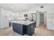 Modern kitchen featuring white cabinets, stainless steel appliances, and a large island with dark blue base at 4015 Overlook Ne Dr, St Petersburg, FL 33703