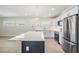 Spacious kitchen with white cabinets, stainless steel appliances, and a large island with bar seating at 4015 Overlook Ne Dr, St Petersburg, FL 33703