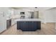 Well-appointed kitchen features stainless appliances, white cabinets, and a large center island at 4015 Overlook Ne Dr, St Petersburg, FL 33703