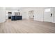 Bright living space with light wood floors, white walls, and a glimpse of the modern kitchen at 4015 Overlook Ne Dr, St Petersburg, FL 33703
