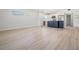 Open-concept living space featuring an updated kitchen and light wood flooring at 4015 Overlook Ne Dr, St Petersburg, FL 33703
