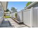 Side yard with a stone paver walkway, lush landscaping, and a tall privacy fence at 4015 Overlook Ne Dr, St Petersburg, FL 33703