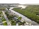 Aerial view of waterfront homes with private docks along a tranquil waterway surrounded by lush greenery and residential areas at 4157 Marine Pkwy, New Port Richey, FL 34652