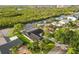 Aerial view of a charming home with lush green surroundings and waterfront access on a sunny day at 4157 Marine Pkwy, New Port Richey, FL 34652