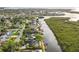 High-angle view of waterfront neighborhood lined with single-Gathering homes and lush greenery at 4157 Marine Pkwy, New Port Richey, FL 34652