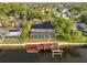 Aerial view of waterfront homes with screened-in pools and private docks, showcasing serene waterfront living at 4157 Marine Pkwy, New Port Richey, FL 34652