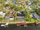 Aerial view of waterfront homes with private docks along a tranquil waterway surrounded by lush greenery and residential areas at 4157 Marine Pkwy, New Port Richey, FL 34652