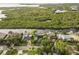 Aerial view of a community with waterfront homes, lush greenery, and private docks on a sunny day at 4157 Marine Pkwy, New Port Richey, FL 34652