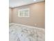 Bright bedroom with tile floors and a window with plantation shutters at 4157 Marine Pkwy, New Port Richey, FL 34652