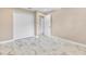Bedroom with neutral colors, and closet featuring marble-patterned tile flooring at 4157 Marine Pkwy, New Port Richey, FL 34652