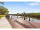 Private boat dock featuring a boat lift, steps down to the water, and plenty of space for enjoying the view at 4157 Marine Pkwy, New Port Richey, FL 34652