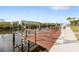 Private boat dock with a boat lift and a railing for safety at 4157 Marine Pkwy, New Port Richey, FL 34652