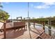 View of the wooden dock with bench seating and waterfront access, perfect for enjoying the serene surroundings at 4157 Marine Pkwy, New Port Richey, FL 34652