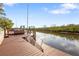 Waterfront dock featuring wood decking, bench seating, and river access for boating and enjoying the peaceful surroundings at 4157 Marine Pkwy, New Port Richey, FL 34652